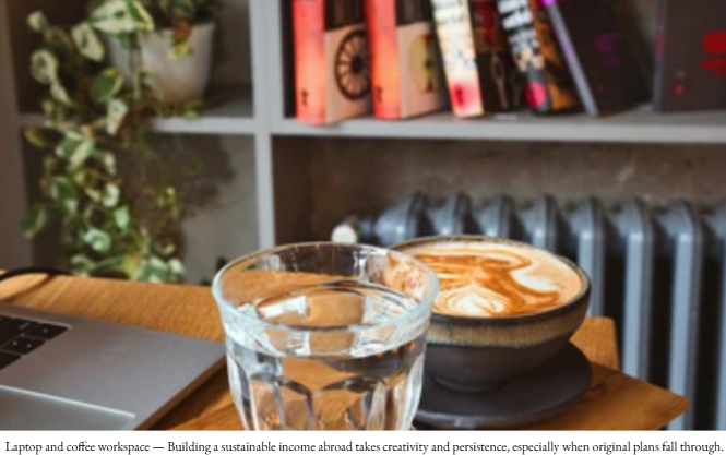 Laptop and coffee on a library table, representing remote work and digital income planning abroad