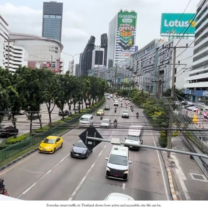 Street traffic scene in Thailand with cars and motorbikes.
