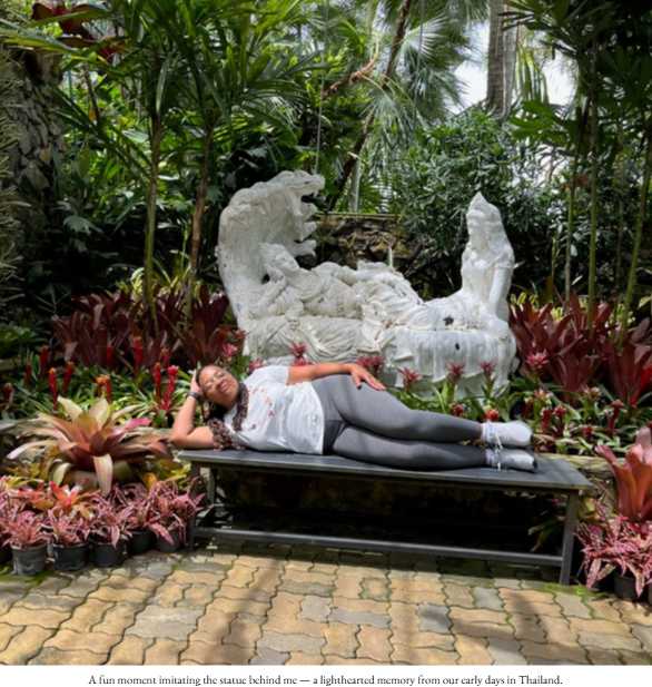 Person lying on a booth imitating a statue behind them in Thailand.